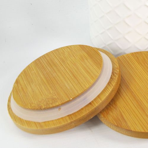 Elegant Duo: Embossed Cream Ceramic Canisters with Bamboo Lids - plants - express.com