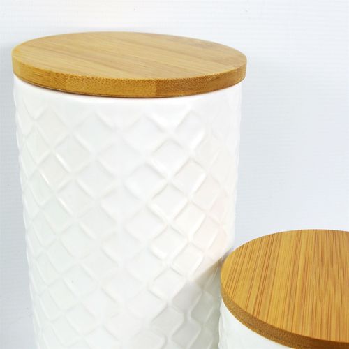 Elegant Duo: Embossed Cream Ceramic Canisters with Bamboo Lids - plants - express.com